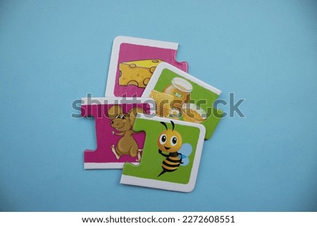 Animal picture puzzles are animal picture puzzles with mouse, cheese, honey bee and honey images mixed together on a blue background.