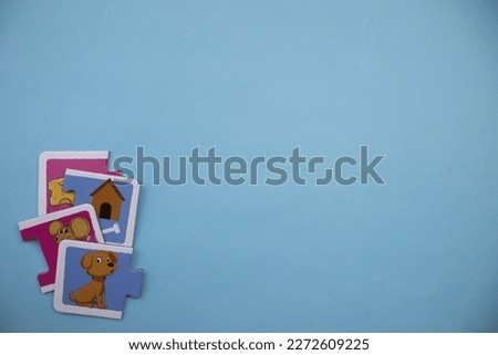 Animal picture puzzles, animal picture puzzles with pictures of mouse, cheese, hut and dog mixed up on the left of a blue background.