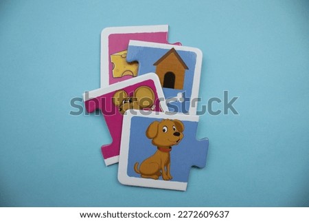 Animal picture puzzles are animal picture puzzles with pictures of mouse, cheese, hut and dog mixed up on a blue background.