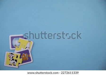 Animal picture puzzles, animal picture puzzles with fish, bell jar, cow and milk mixed in on the left of a blue background.