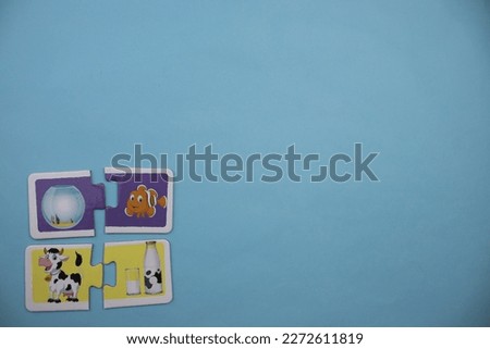 Animal picture puzzles are animal picture puzzles with pictures of fish, bell jar, cow and milk placed on the left of a blue background.