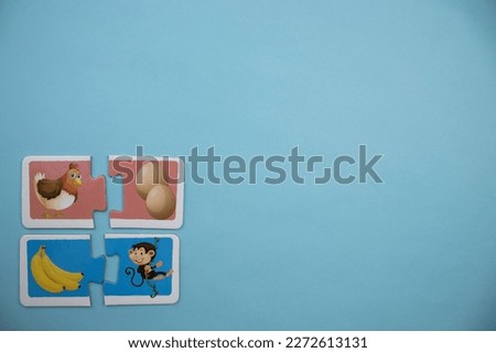 Animal picture puzzles are animal picture puzzles with pictures of chickens, eggs, bananas and monkeys placed on the left of a blue background.