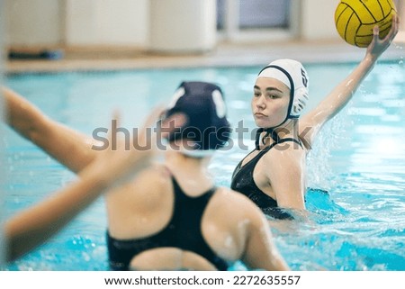 Water polo, swimming pool and sports with women athlete, active and fitness with action, energy and ball. Competitive, team sport and challenge, training and workout, health motivation and cardio
