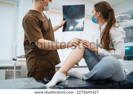 Doctor examines x-ray of patient leg. Foot and sprain concept. Sport exercise injuries.