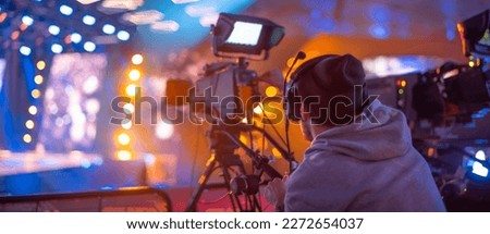 cameraman in the studio on the set of a TV show Royalty-Free Stock Photo #2272654037