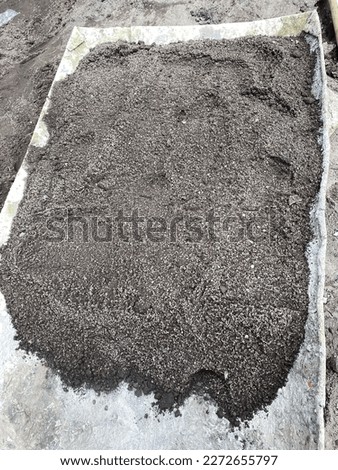 Black Sand on tray as building material on site project