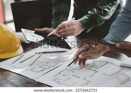 The home design architects are reviewing the house plan draft, the project commissioned by the client, and the custom design before delivery. Interior design and decoration ideas. Royalty-Free Stock Photo #2272662721