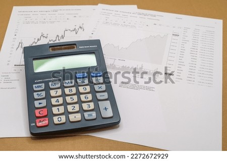 graphs, calculator and papers. Planning and evaluation of investment opportunities with financial data.