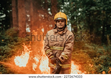 Firefighter at job. Firefighter in dangerous forest areas surrounded by strong fire. Concept of the work of the fire service