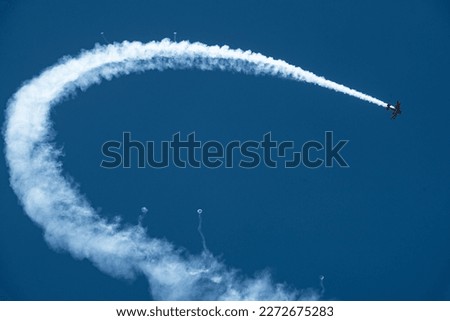 A biplane flies in the airshow Royalty-Free Stock Photo #2272675283