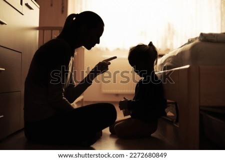 parent correcting dissiplining child for bad behavior	 Royalty-Free Stock Photo #2272680849