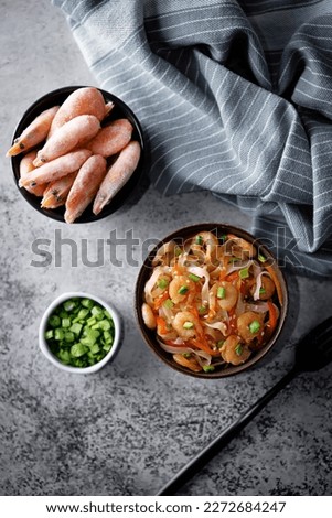 Funchosa with shrimp and vegetables in a plate Pad Thai. tinting. selective focus
