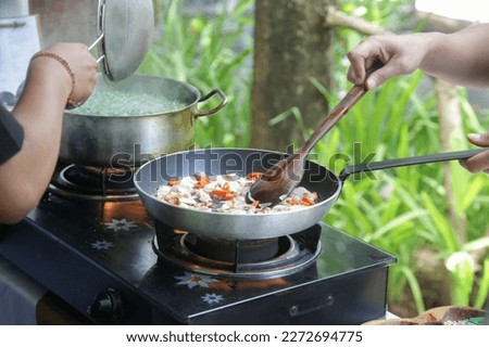 Adult students learning recipe and preparing meal in cooking class Royalty-Free Stock Photo #2272694775