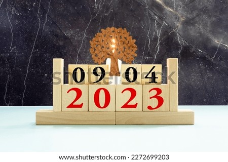 April 9 calendar date text on wooden blocks with blurred park background. Copy space and calendar concept.
