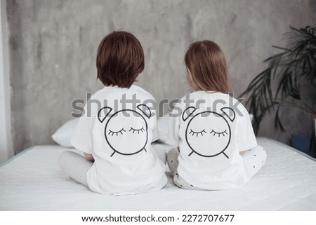 parent and baby and eyes are drawn on pajamas, children go to bed