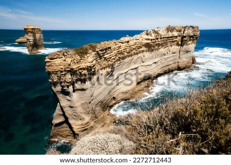The Twelve Apostles are a collection of limestone stacks off the shore of Port Campbell National Park by the Great Ocean Road in Victoria, Australia. Royalty-Free Stock Photo #2272712443