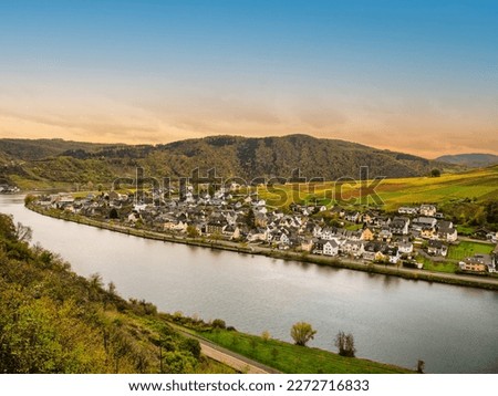 Aerial shot of Ellenz-Poltersdorf village and colourful vineyards on Moselle river during fall in Cochem-Zell district, Germany