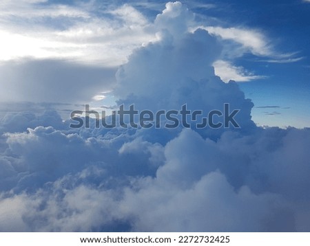 clouds up in the sky pictured in plane