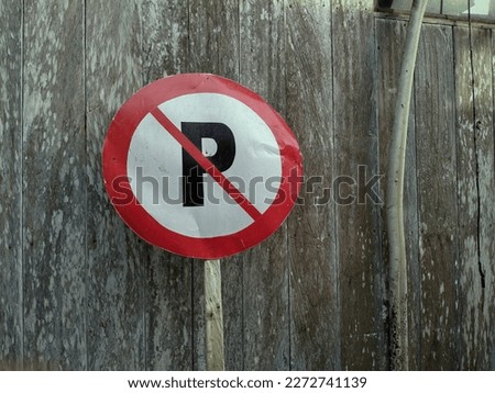 no parking sign with wooden board background