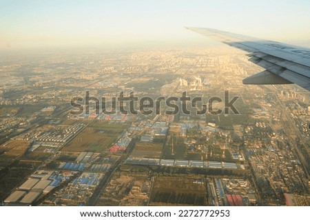 Beijing, 2011, Part of the city under the wings of an airplane in the morning sun