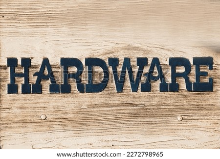 Aged and worn hardware store sign on wood