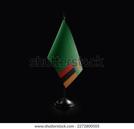 Small national flag of the Zambia on a black background.
