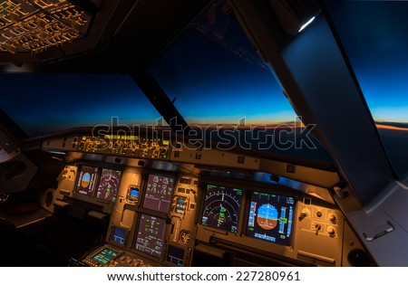 Jet aircraft cockpit at twilight time. Royalty-Free Stock Photo #227280961