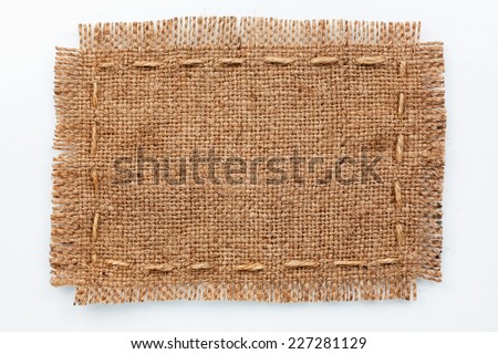 Frame of burlap, lies on a background of burlap  with place for your text,on a white background  Royalty-Free Stock Photo #227281129