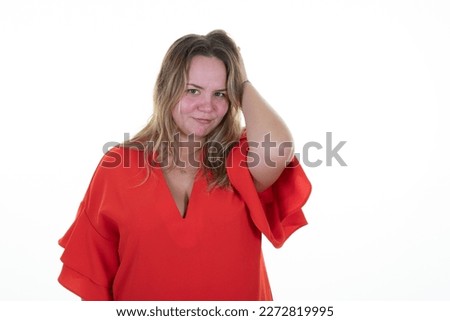 blond overweight beautiful young curvy woman smiling with hands in  hair pensive posing in studio white background