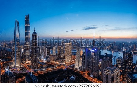 Aerial view of city skyline and modern commercial buildings in Shanghai at sunset, China.