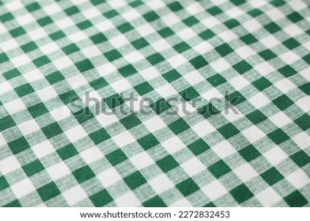 Green checkered tablecloth as background, closeup view