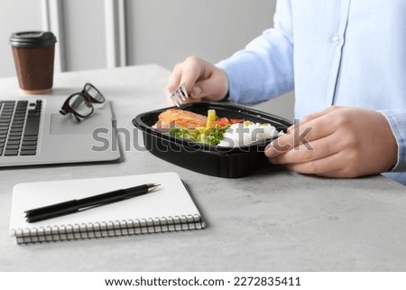 Office employee having business lunch at workplace, closeup Royalty-Free Stock Photo #2272835411