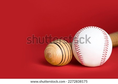 Wooden baseball bat and ball on red background, closeup. Space for text