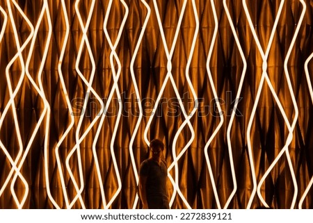 Futuristic neon light technology cyber sci fi texture background full frame and male man, design interior wall. Installation of LED strip lights as energy saving illumination, man silhouette