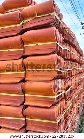 Close Up. Pile of  red roofing tiles packaged. Roof construction.