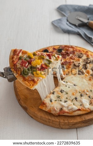 Top view of mix pizza with mozzarella cheese, sausage and kind of vegetables