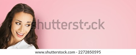 Happy excted smiling woman in white confident cloth looking aside. Business advertisement concept. Brunette businesswoman, isolated rose pink background. Royalty-Free Stock Photo #2272850595