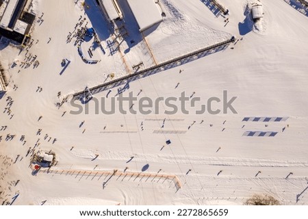 Drone photography of ski resort in mountain, ski lifts, people skying during sunny winter day