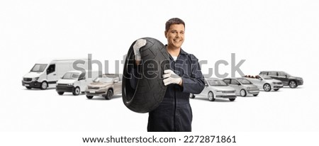 Parked vehicles and a mechanic holding a tire isolated on white background