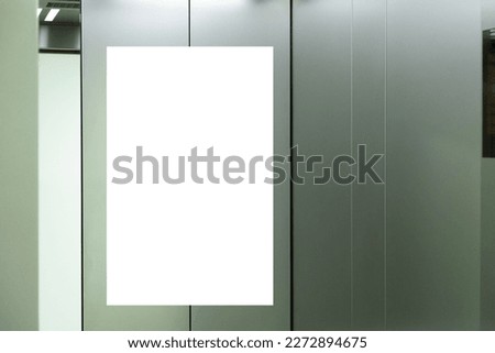 Mock up. Vertical poster media template frame hanging on the wall inside elevator lift Royalty-Free Stock Photo #2272894675