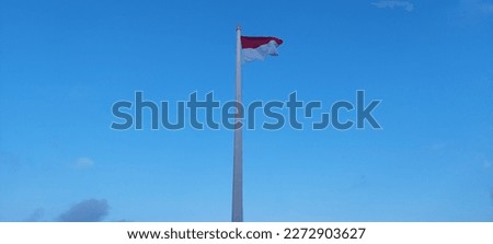 waving the red and white flag under the blue sky