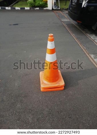 police cone is a traffic sign marker to regulate vehicles in and out