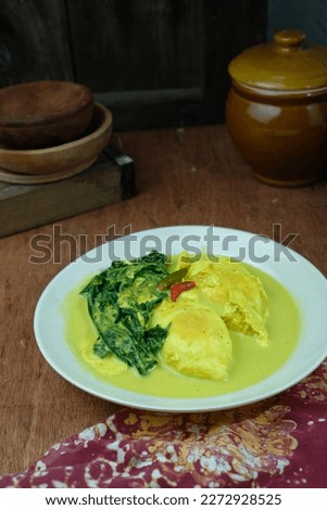 Telur itik masak lemak or egg curry with belimbing buluh. Traditional dish of coconut based food with spicy chili and turmeric.
