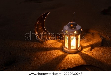 Ramadan and Eid Mubarak Dark Theme background Lantern lamp and Crescent moon on the sand, Islamic new year image Royalty-Free Stock Photo #2272930963