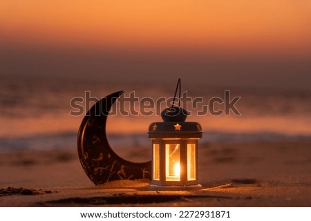 Lantern lamp with beach sunset view, Islamic new year concept image Royalty-Free Stock Photo #2272931871