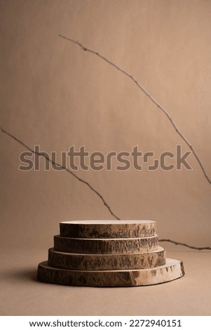 Rustic wood podium display for food, perfume, jewellery and cosmetic products on dark brown background. Front view.