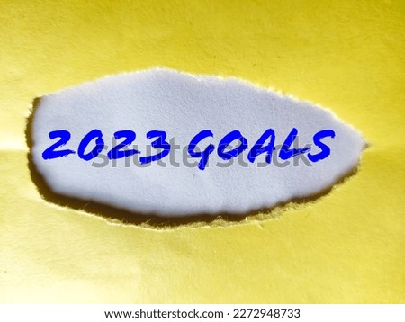 2023 GOALS message written under torn brown paper.
