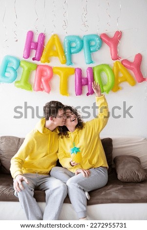 Cheerful family young couple celebrating birthday at home