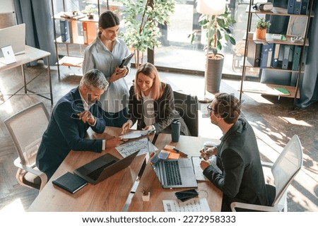 Cooperative business. Group of people are working in the modern office. Royalty-Free Stock Photo #2272958333