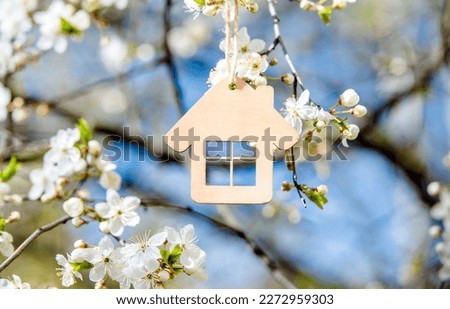 symbol of the house among the white cherry blossoms Royalty-Free Stock Photo #2272959303